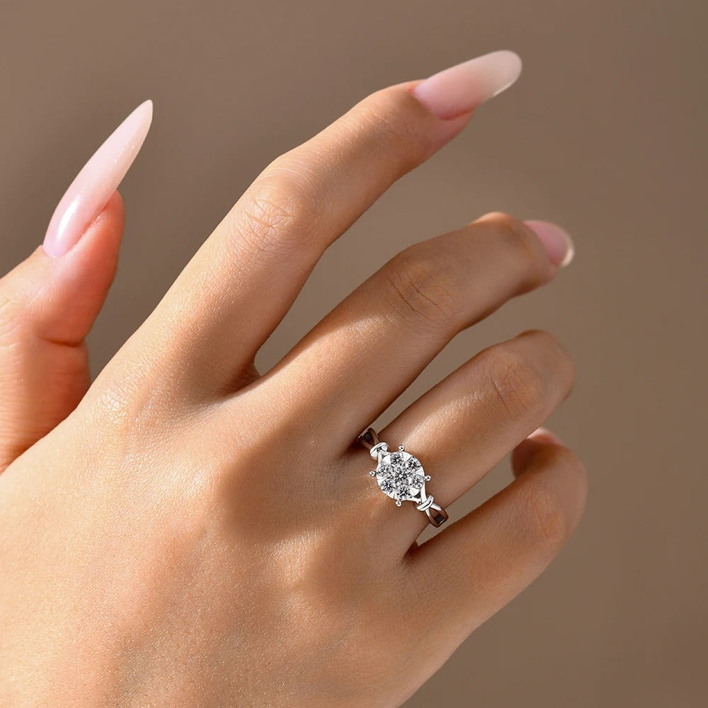 Hand wearing a diamond ring with a neutral background