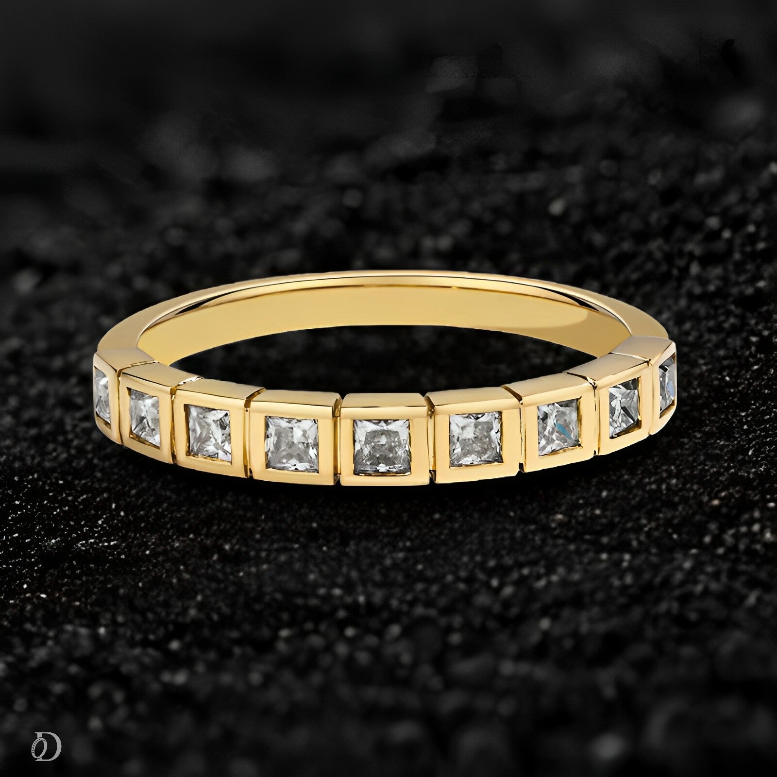 Gold ring with embedded diamonds on a dark textured background