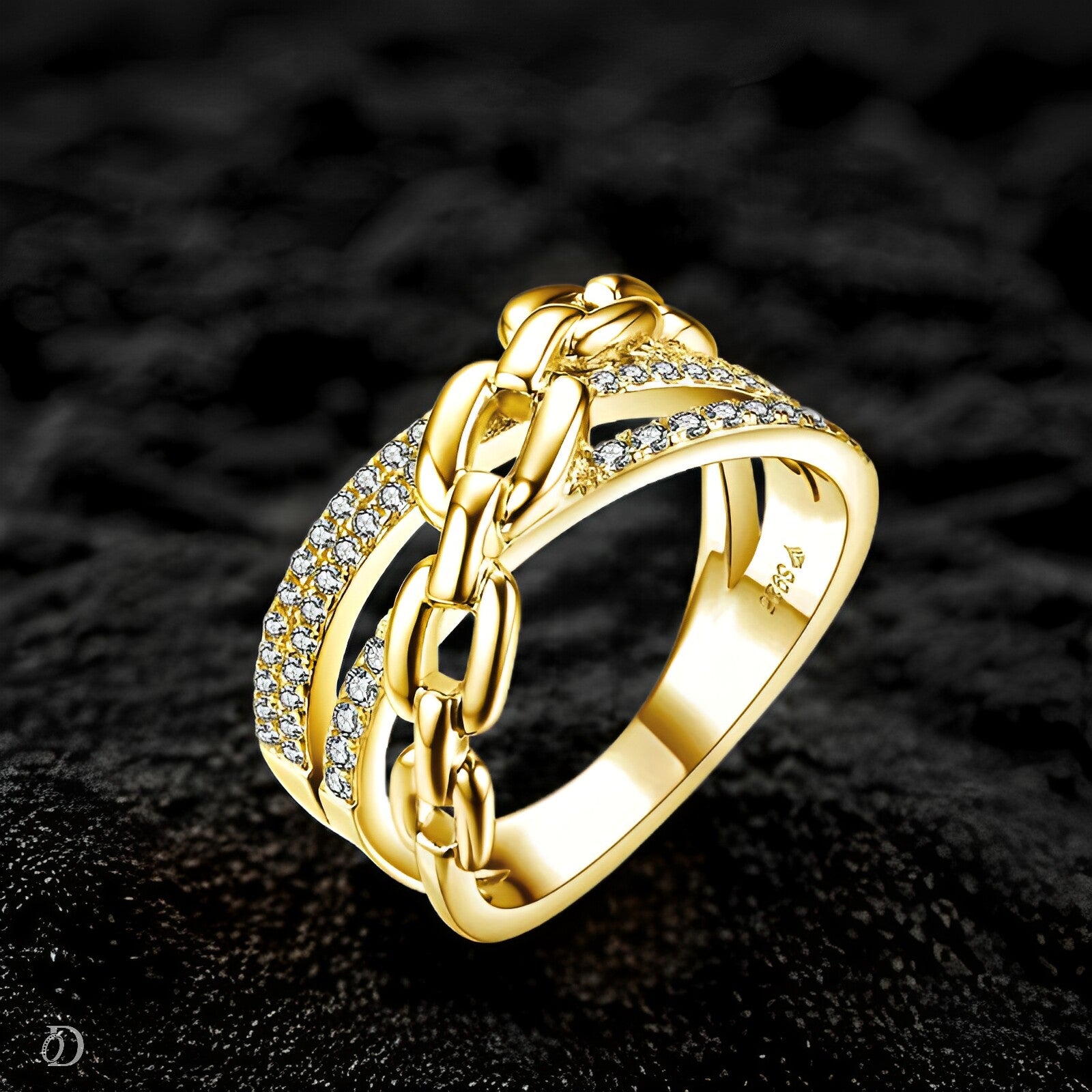 Gold chain ring with embedded diamonds on a dark textured background