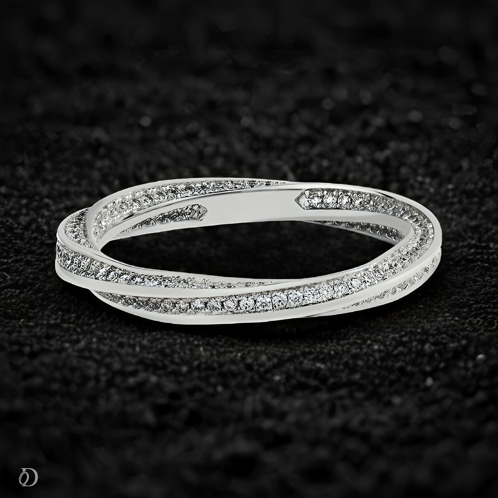 Silver bracelet with small diamonds on a dark textured background