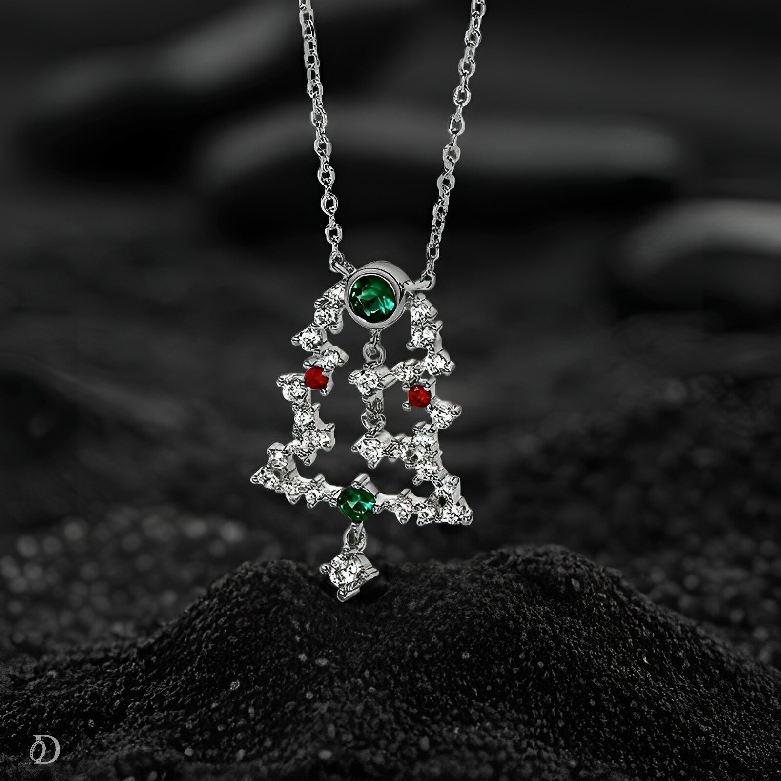 Silver necklace with a star-shaped pendant on a black textured surface