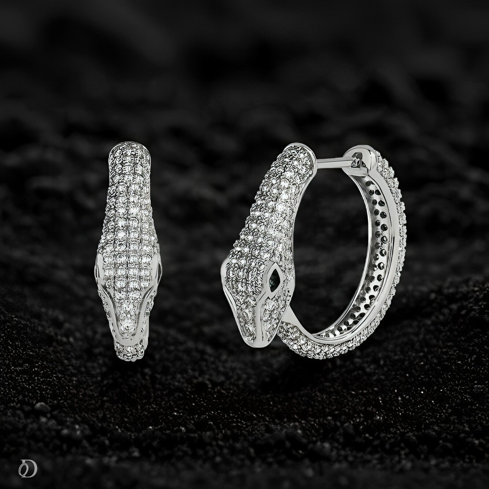 Silver hoop earrings with gemstones on a dark textured background