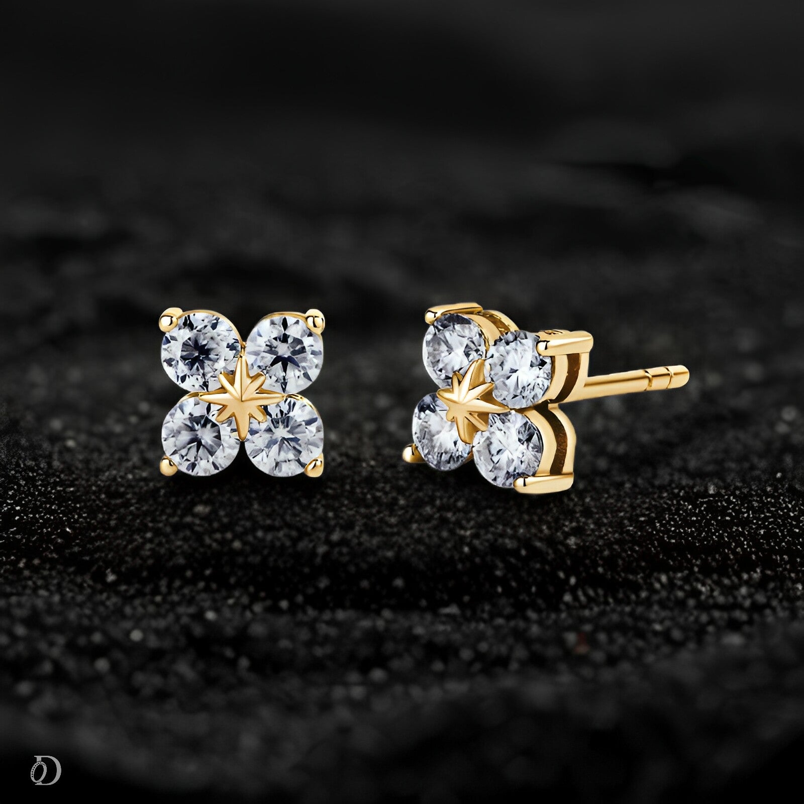 Gold and crystal stud earrings on a black background