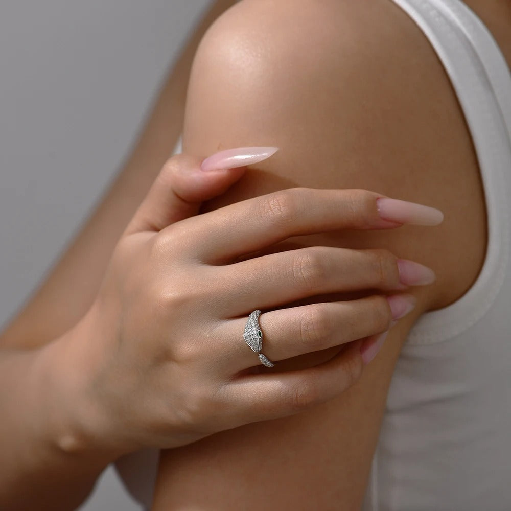 Hand with a ring on a knee against a neutral background