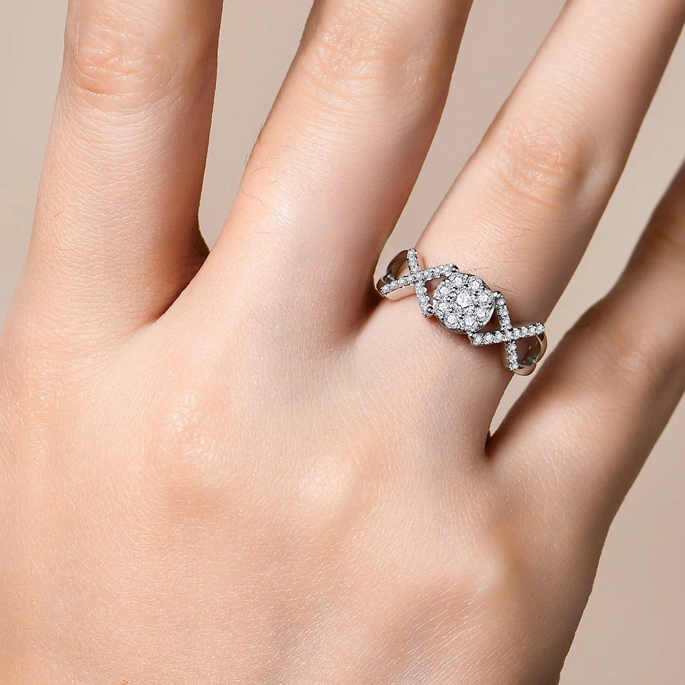 Silver ring with a diamond on a hand against a beige background