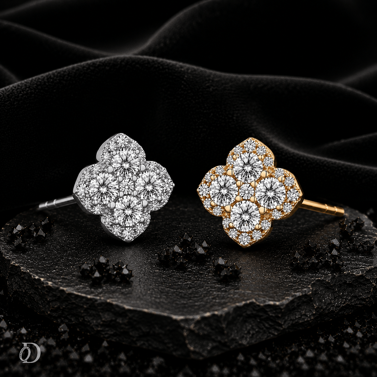 Two flower-shaped cluster stud earrings displayed on a dark textured surface with black fabric in the background. One earring is silver-toned with clear stones, and the other is gold-toned with clear stones.