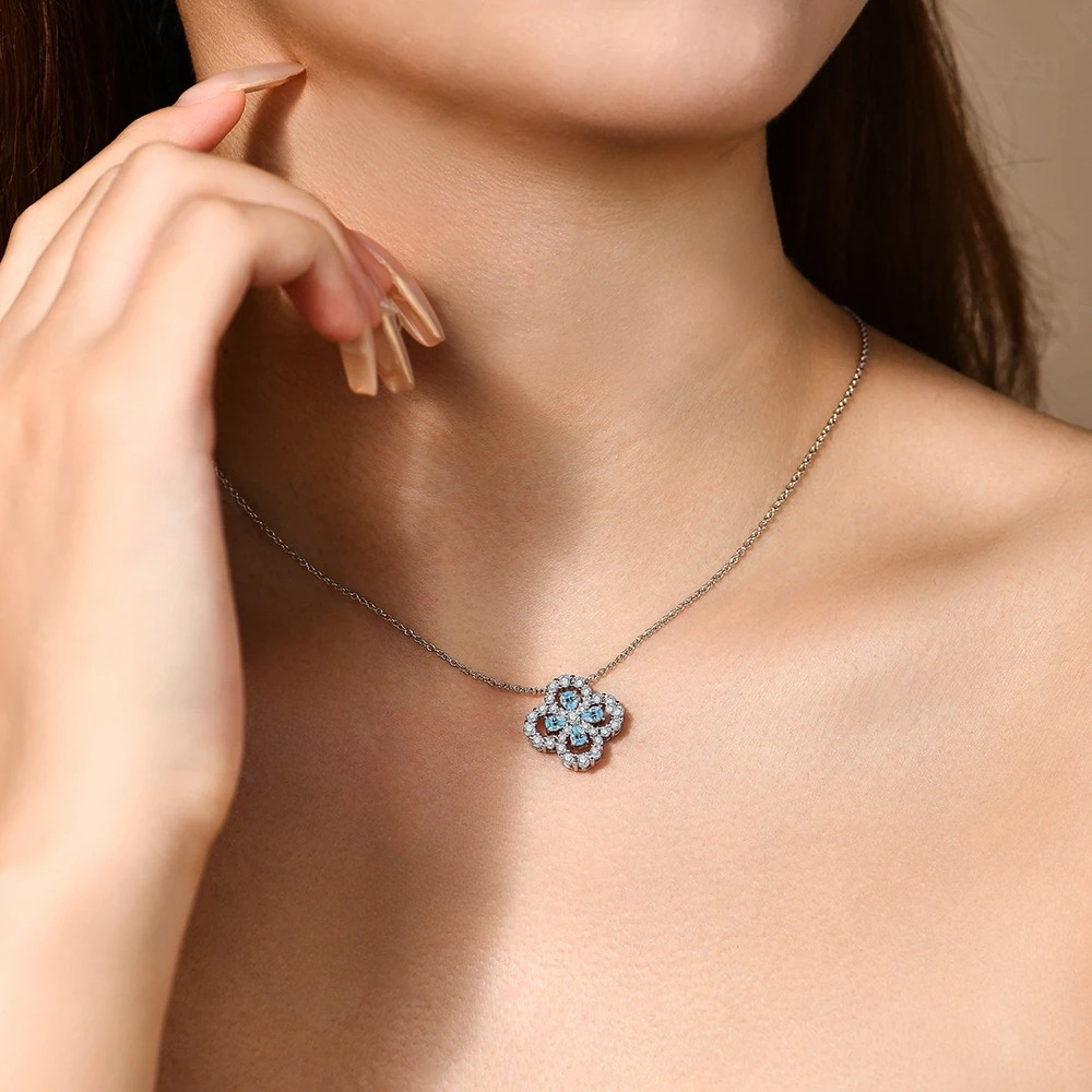 Necklace with a floral pendant worn by a person