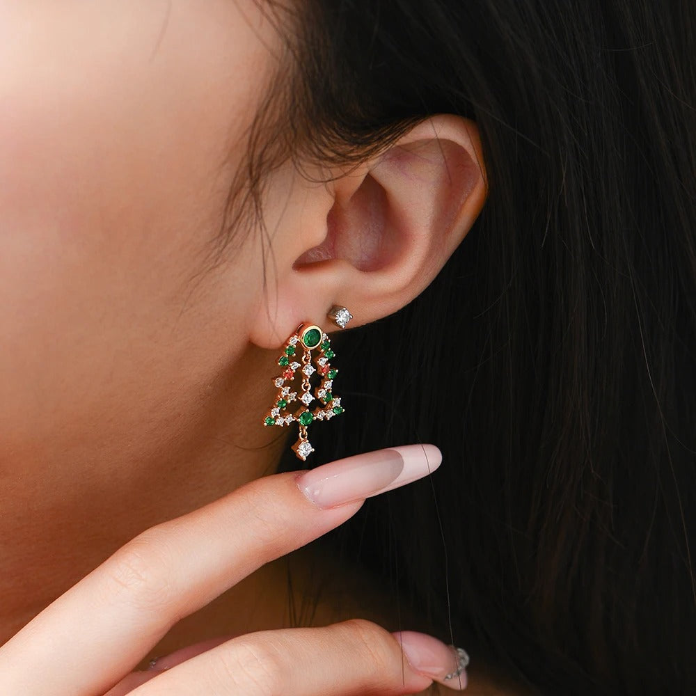 Close-up of a person wearing a green and red earring with a blurred background