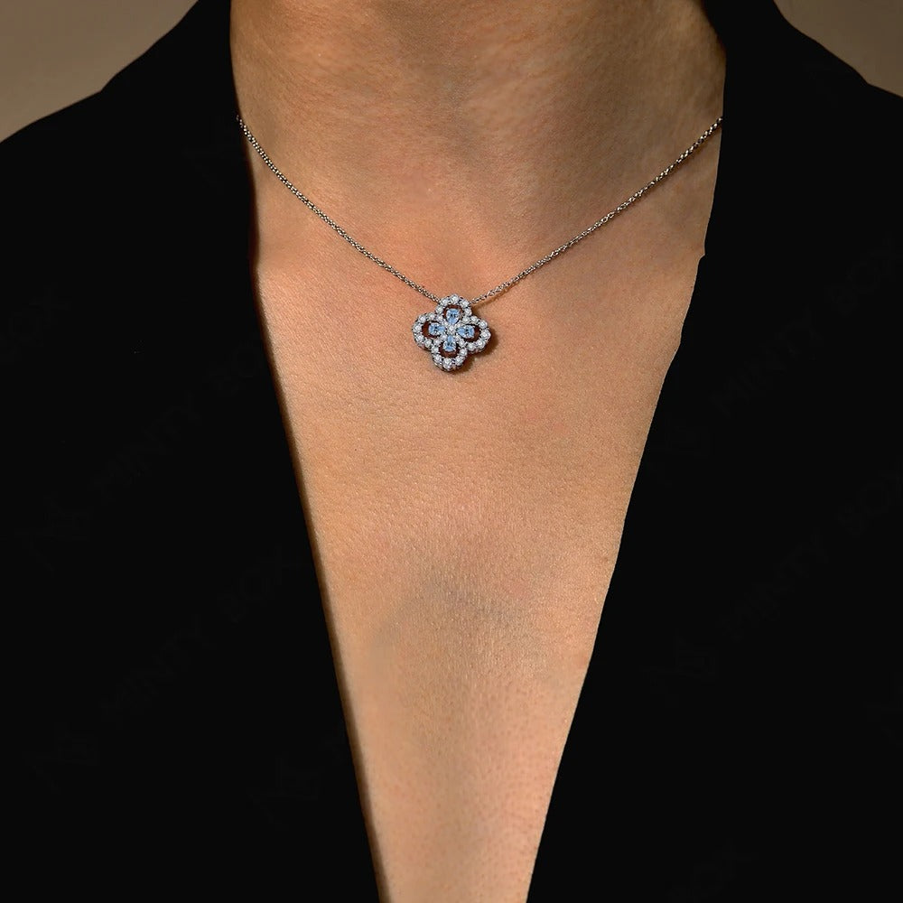 Necklace with a floral pendant on a person wearing a black top