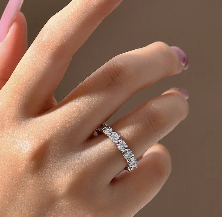 Diamond ring on a hand with a neutral background
