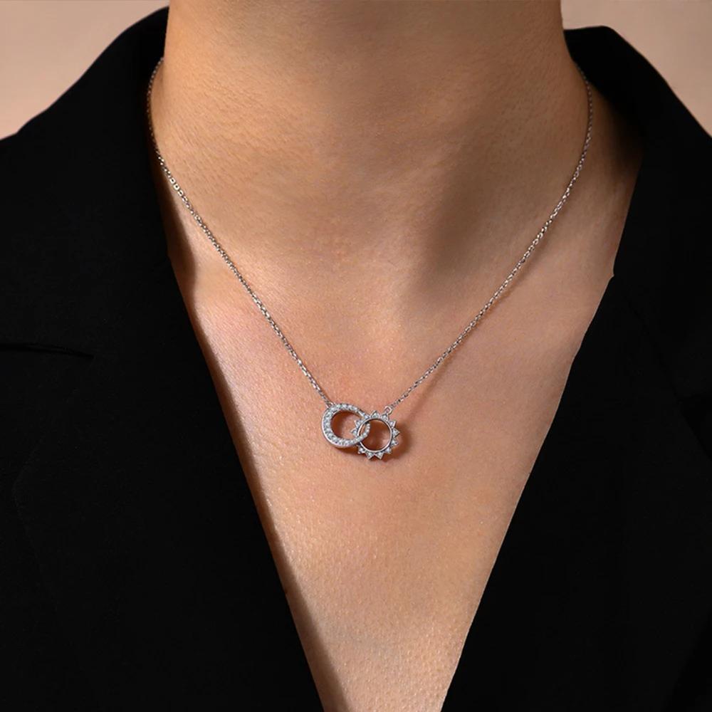 Necklace with a unique pendant worn by a person against a neutral background
