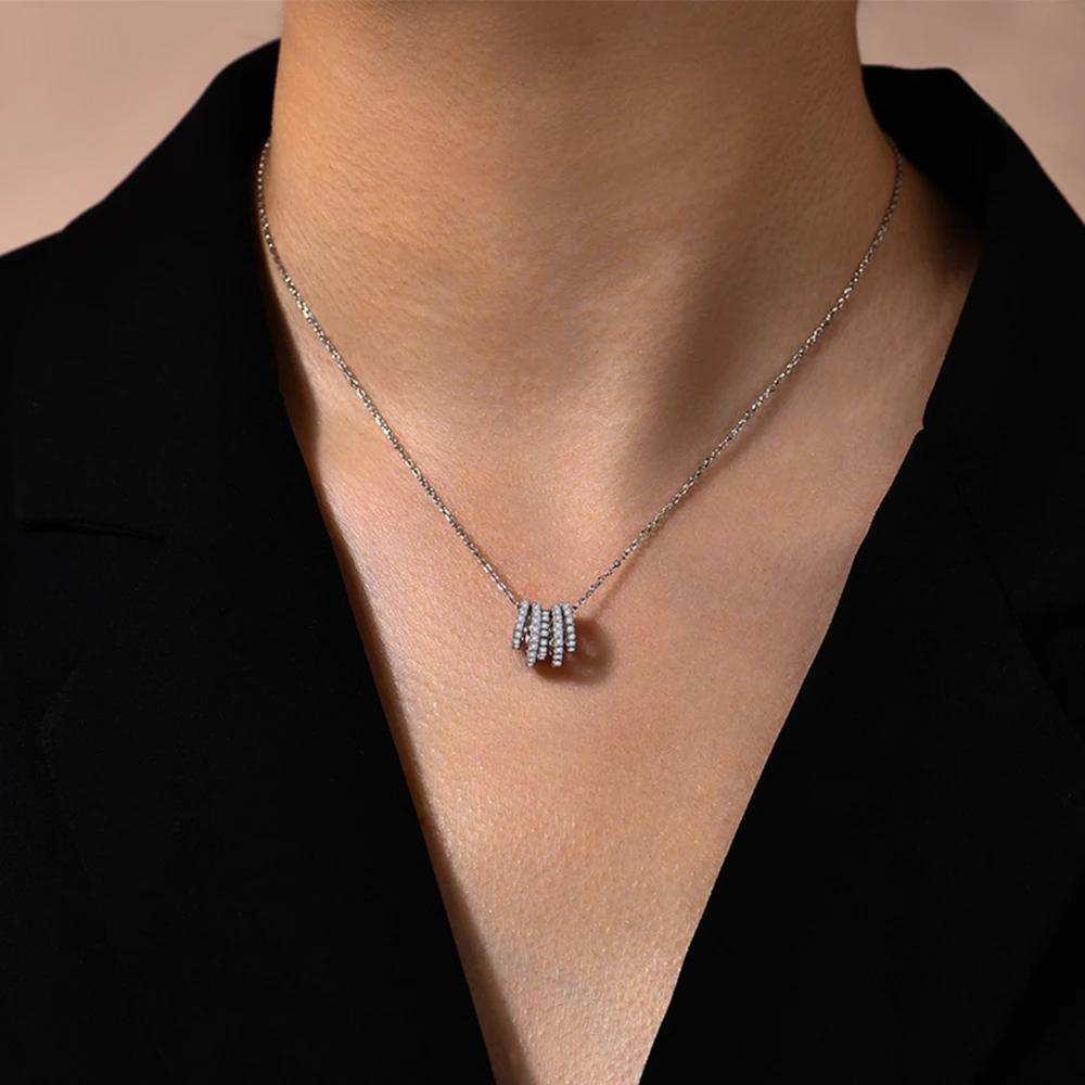 Necklace with a pendant worn by a person against a neutral background