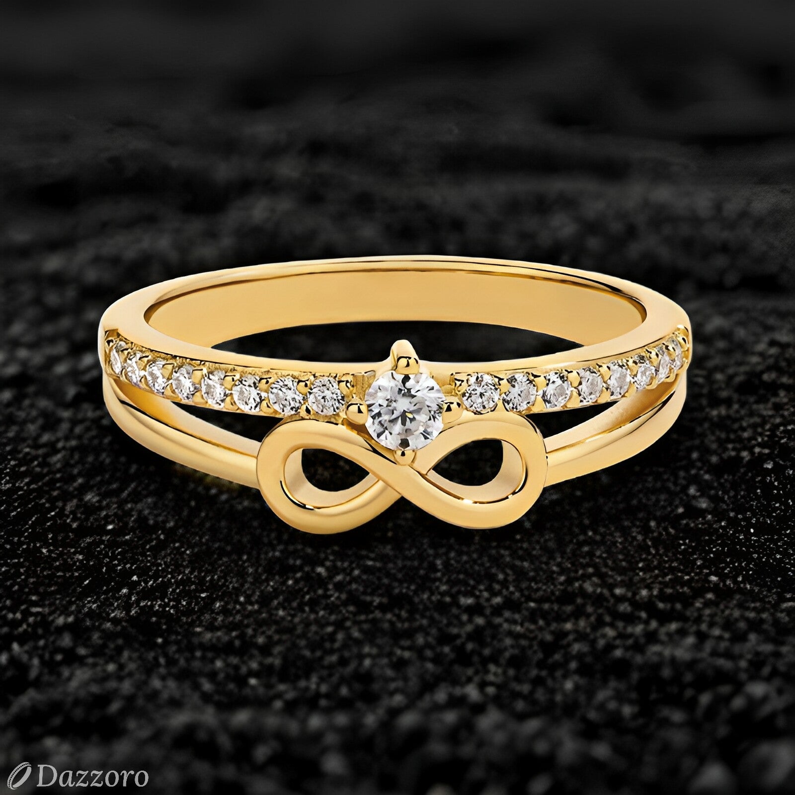 Gold ring with diamond infinity symbol on a black background