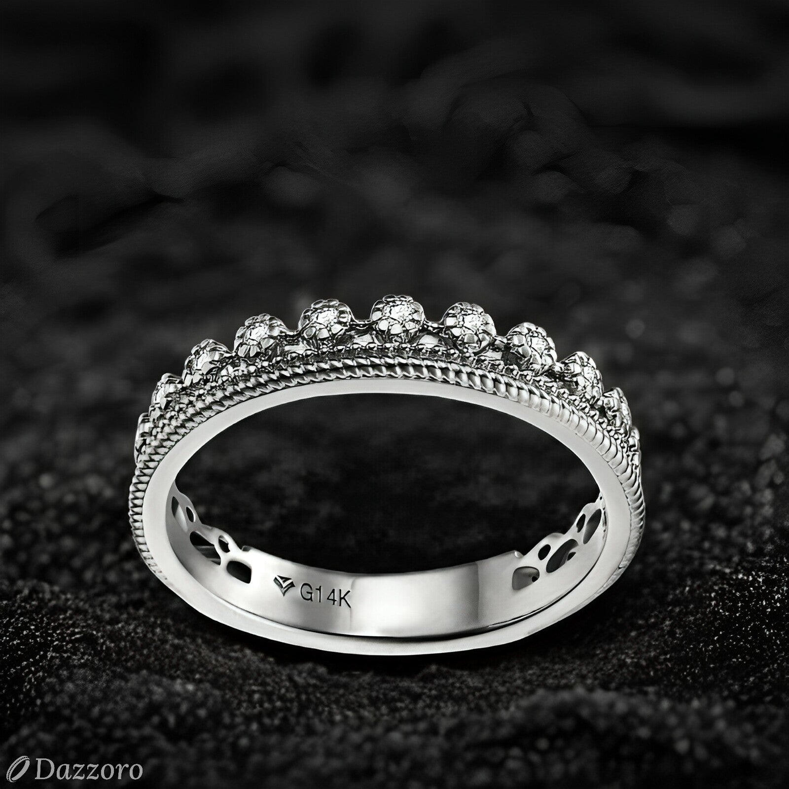 Silver ring with gemstones on a dark textured background, featuring the brand 'Dazzzoro'.