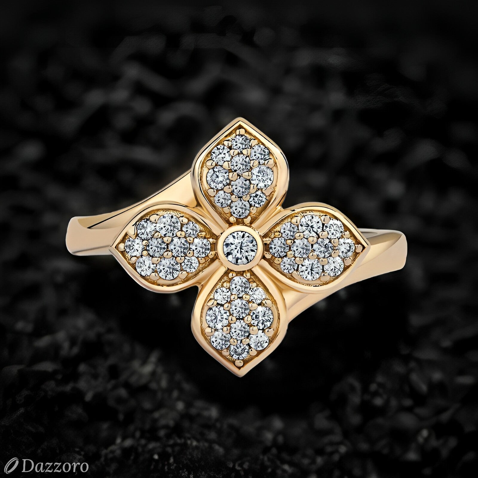 Gold ring with diamond accents on a textured black background, Dazzoro brand visible.