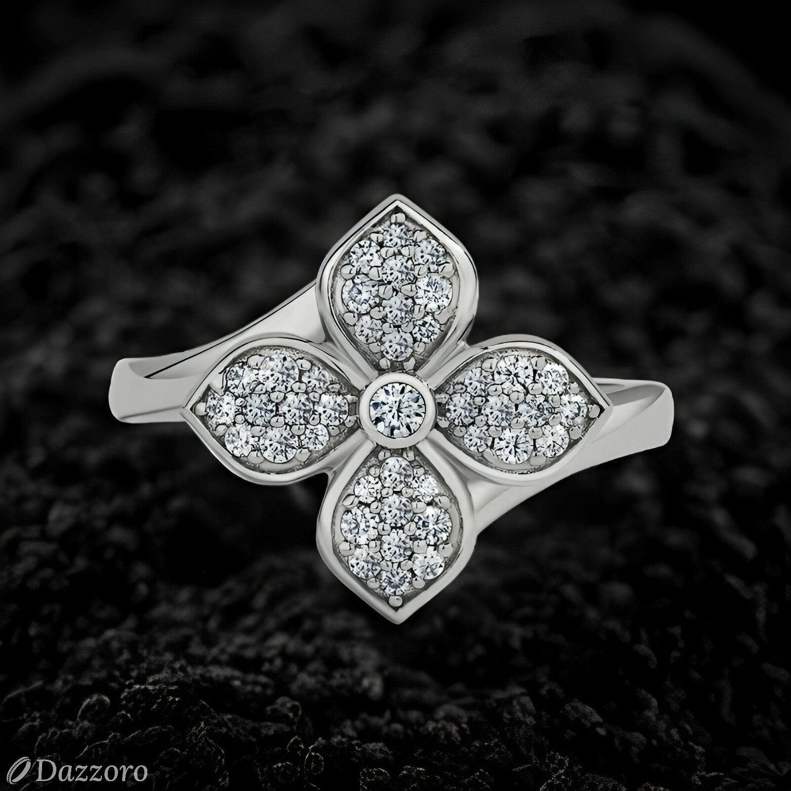 Silver ring with diamond accents on a textured black background, Dazzzoro brand visible.
