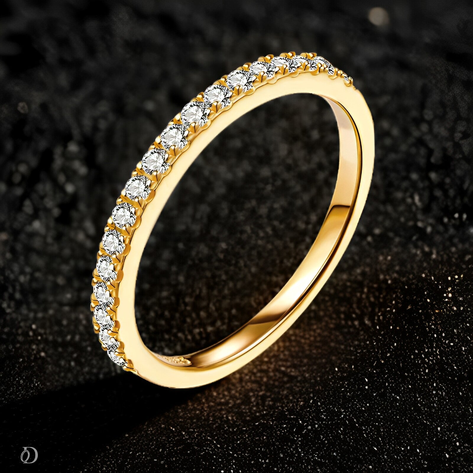 Gold ring with diamonds on a dark textured background