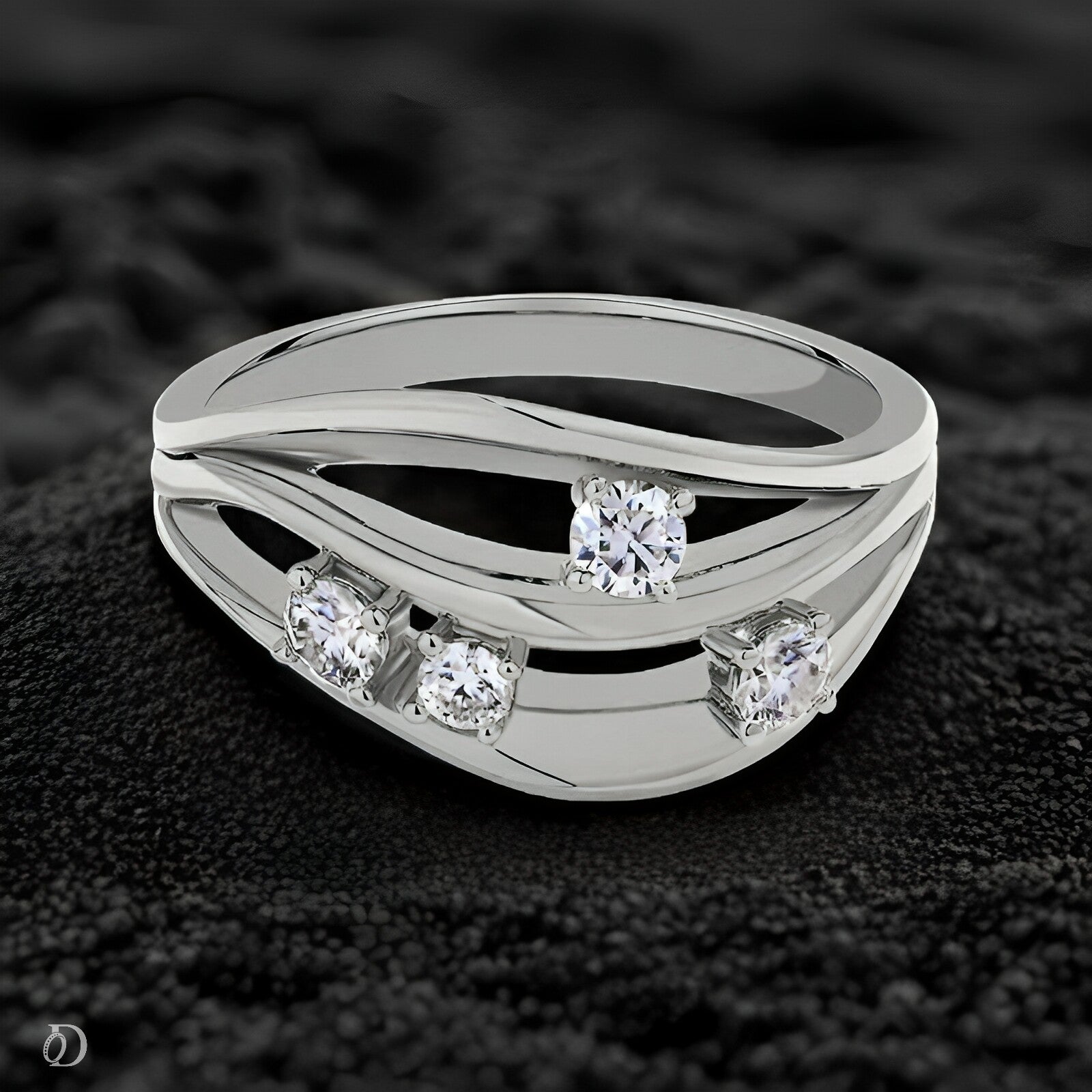 Silver ring with multiple diamonds on a dark textured background