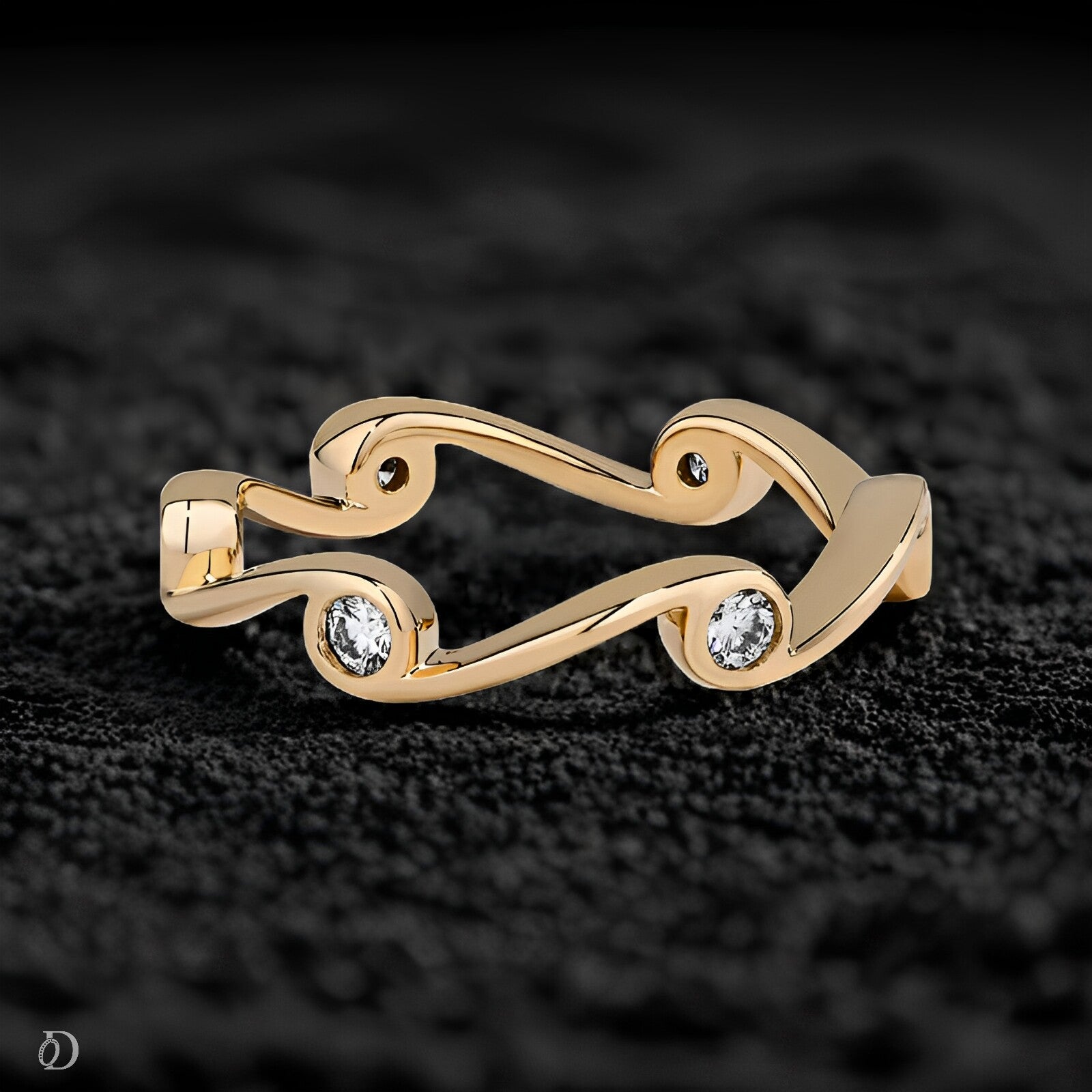 Gold ring with two diamonds on a black textured background