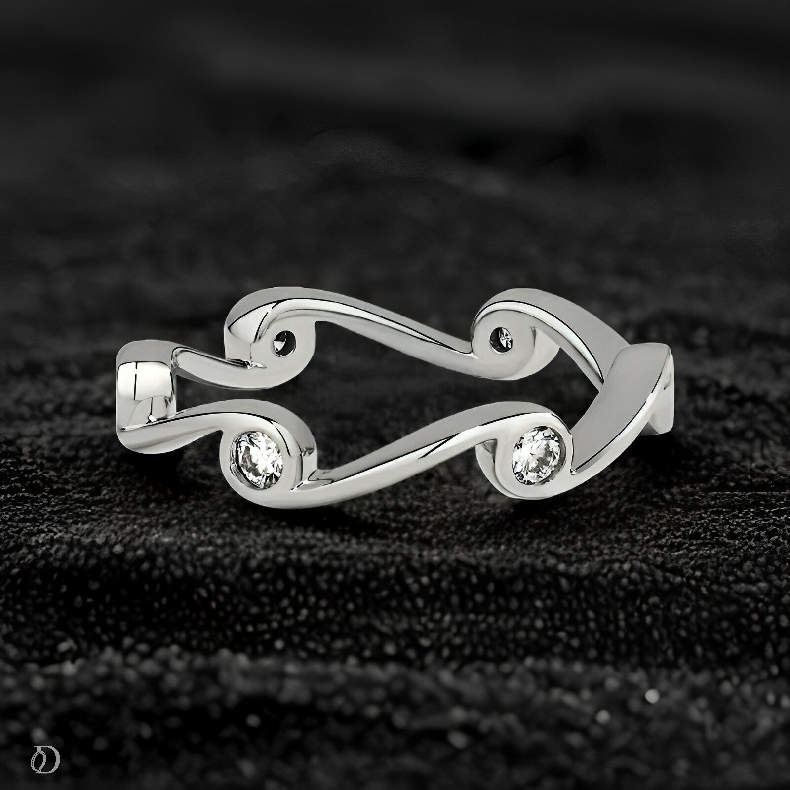 Silver ring with three diamonds on a black textured background