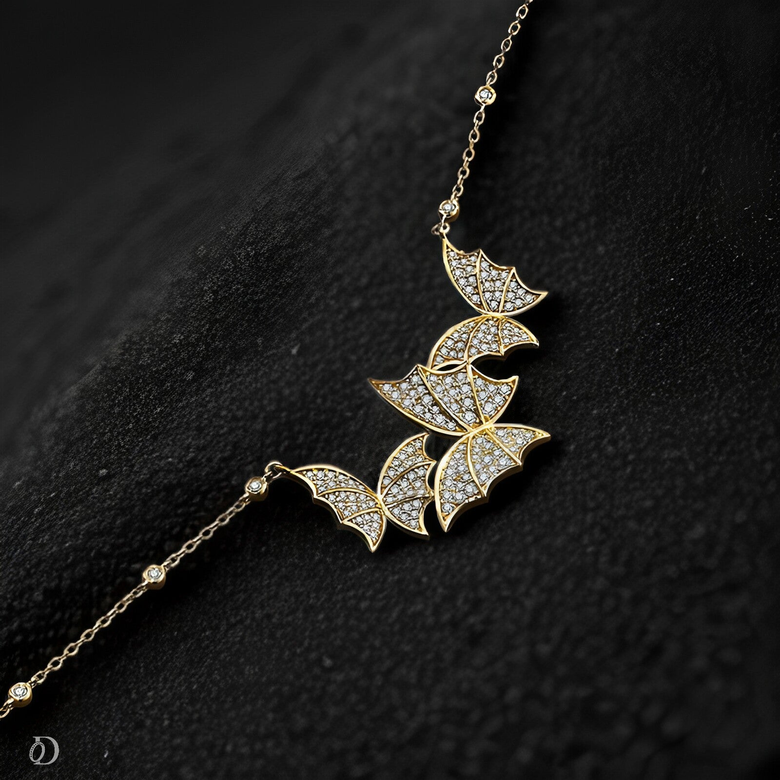 Gold necklace with butter fly-shaped pendants on a dark textured background