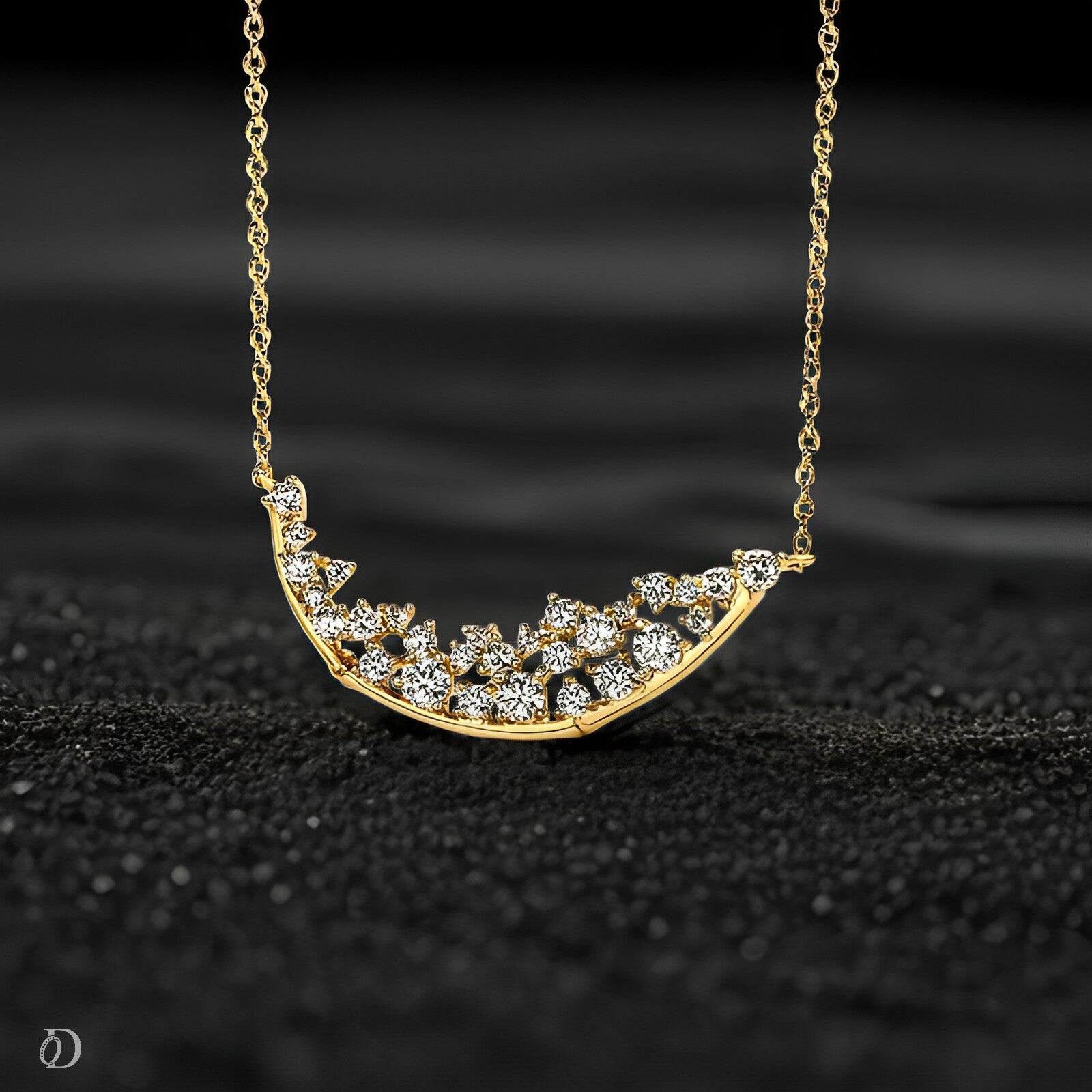 Gold necklace with a crescent moon-shaped pendant on a black textured background