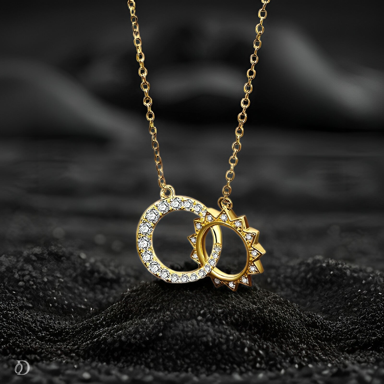 Gold necklace with interlocking rings pendant on a black textured background