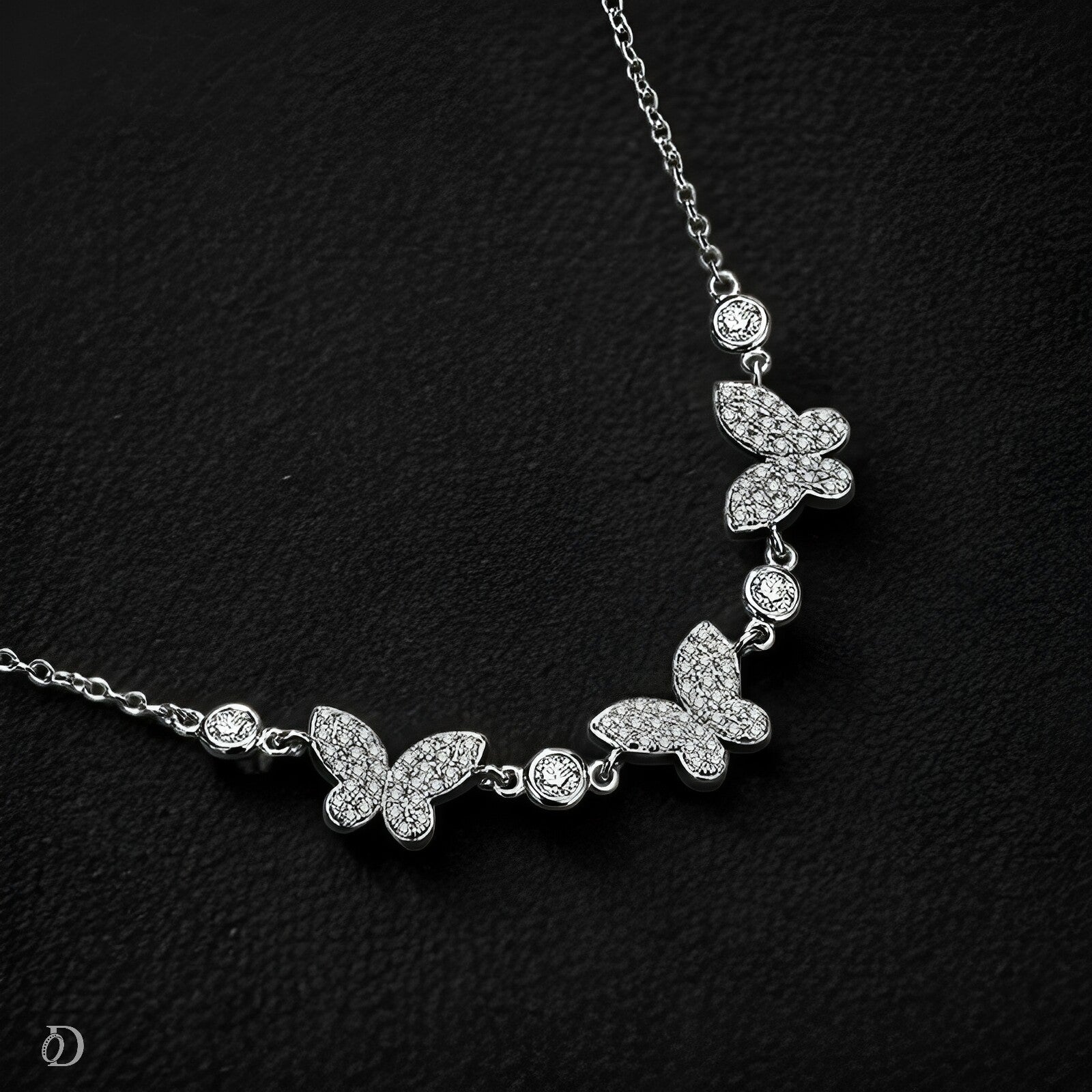 Butterfly necklace with clear stones on a black background