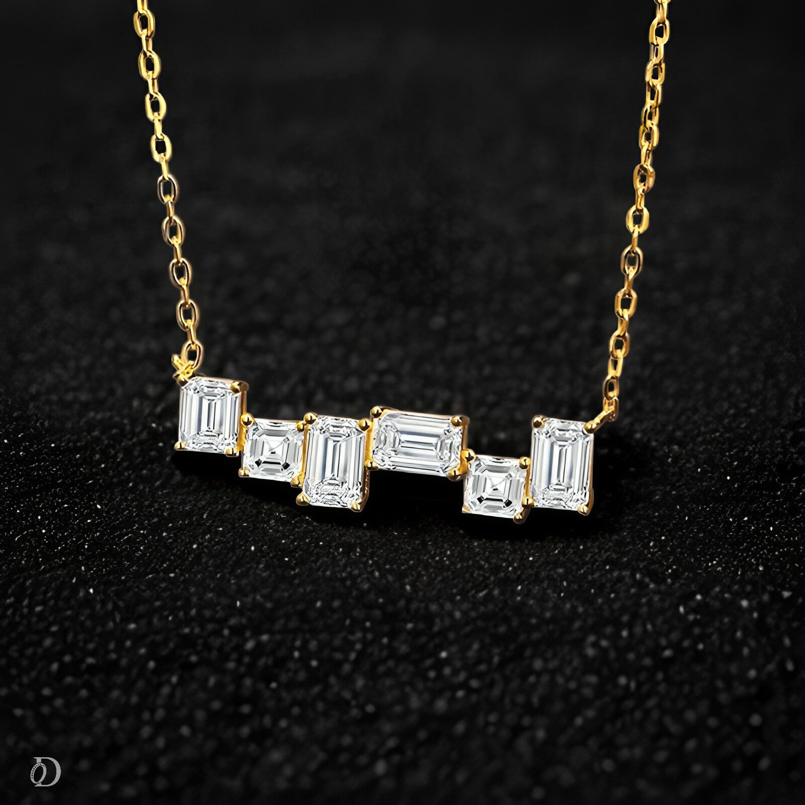 Gold necklace with emerald-cut diamonds on a black background