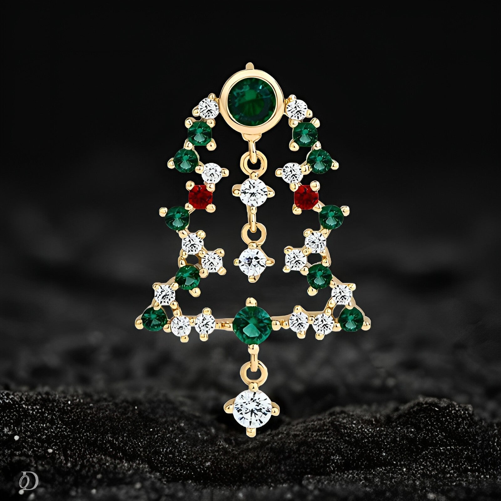 Gold earring with green and red gemstones on a black background