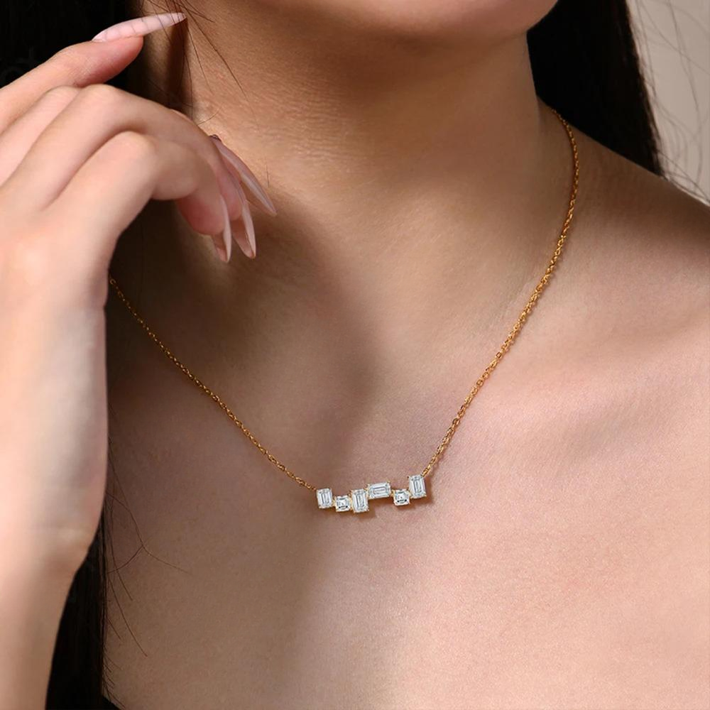 Gold necklace with diamond accents worn by a person