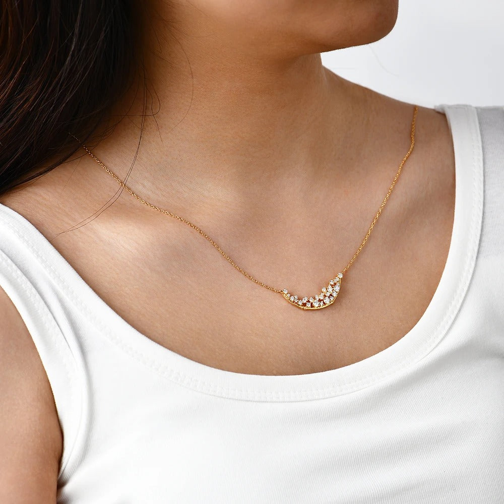 Gold necklace with small diamonds on a white background